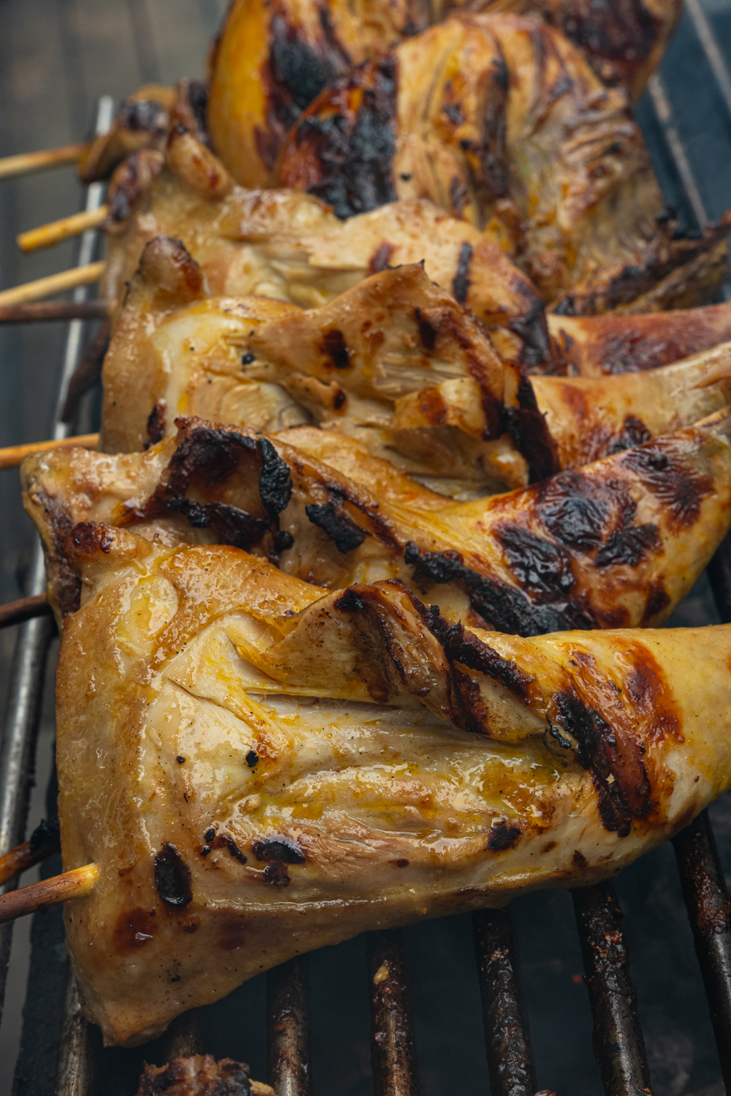 Chicken inasal on a bamboo skewer